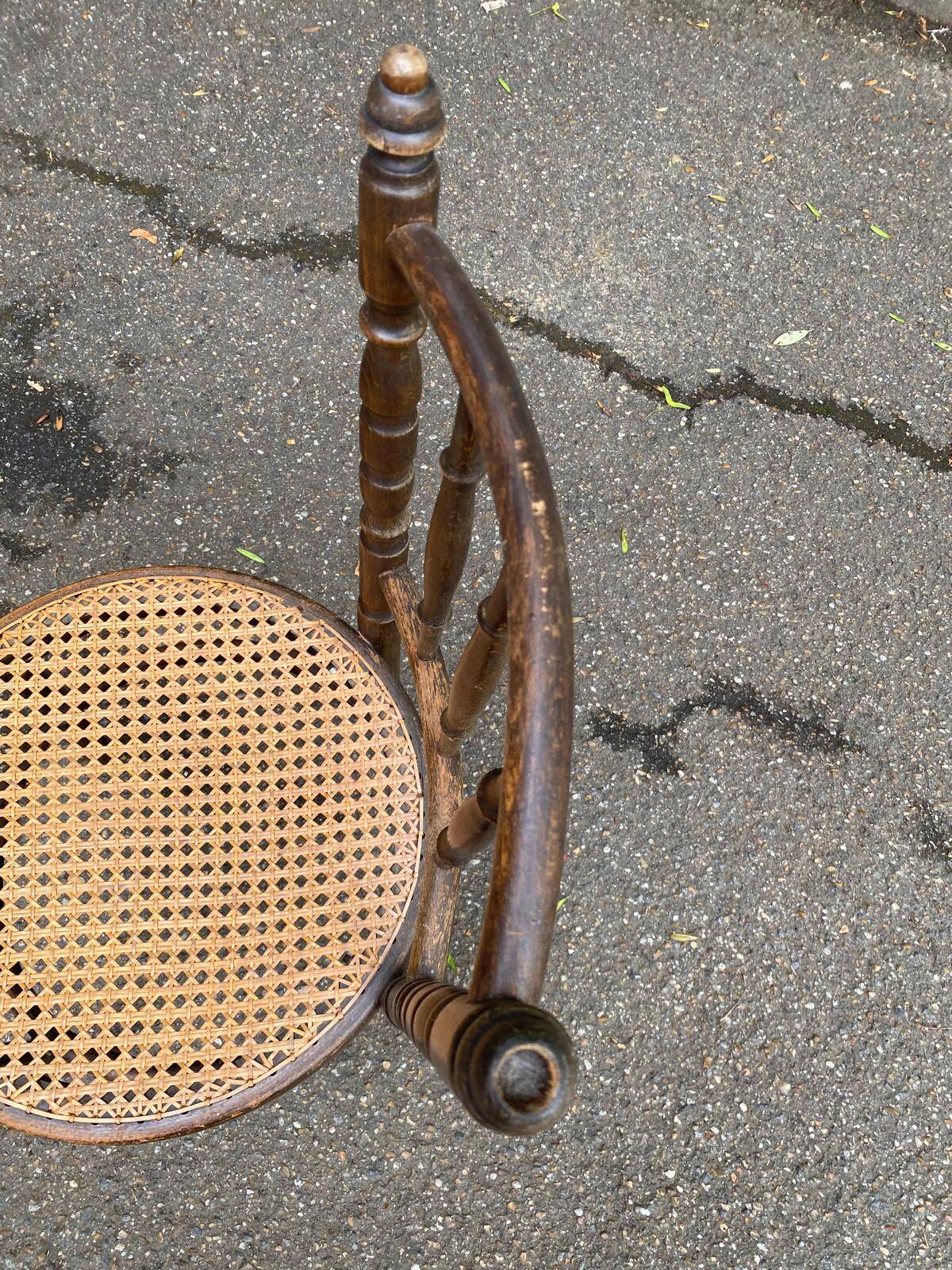 Vintage 19th-century bistro chair made of curved solid wood and caned in the Thonet style.