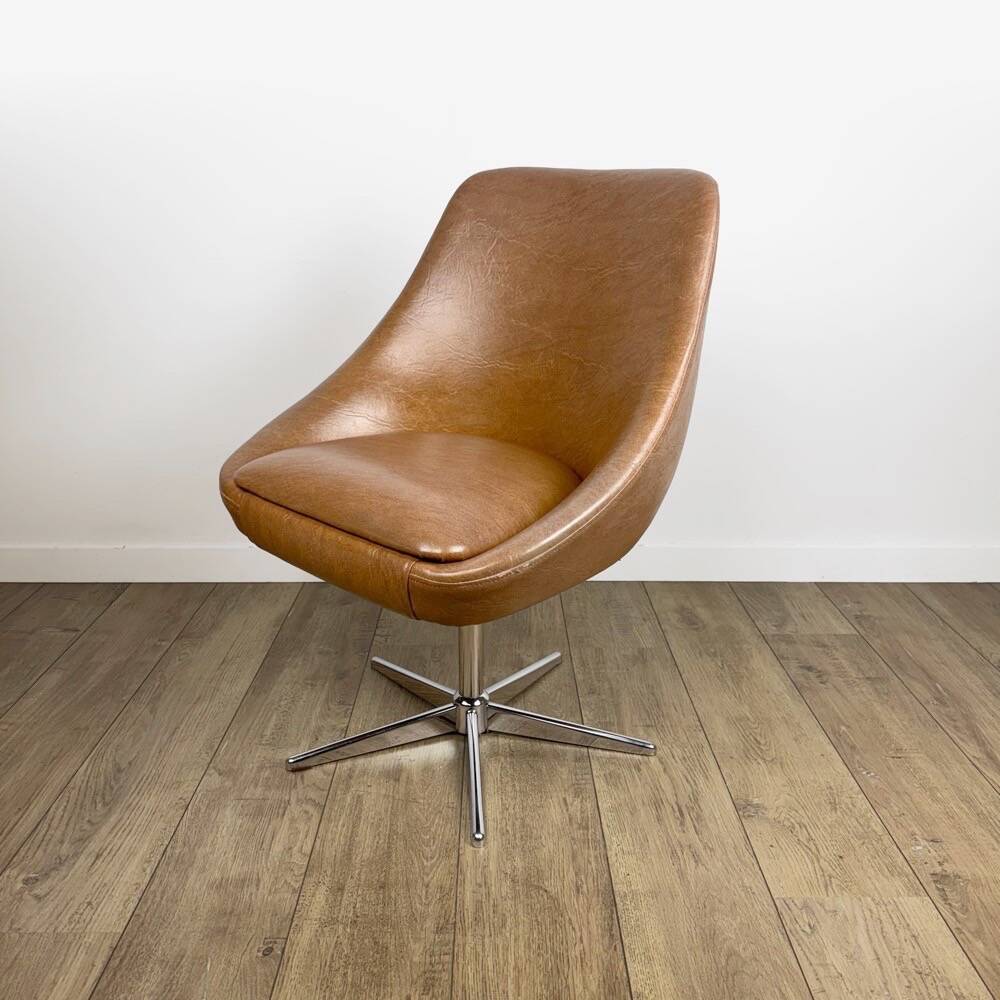 1970s swivel chair with faux leather shell and chrome.
