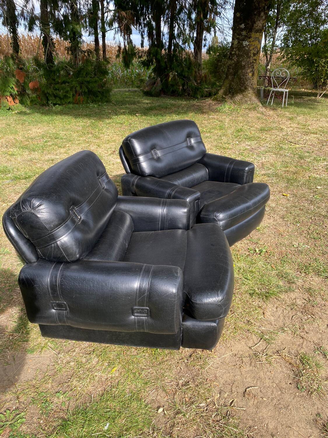 Pair of black imitation leather armchairs