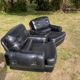 Pair of black imitation leather armchairs