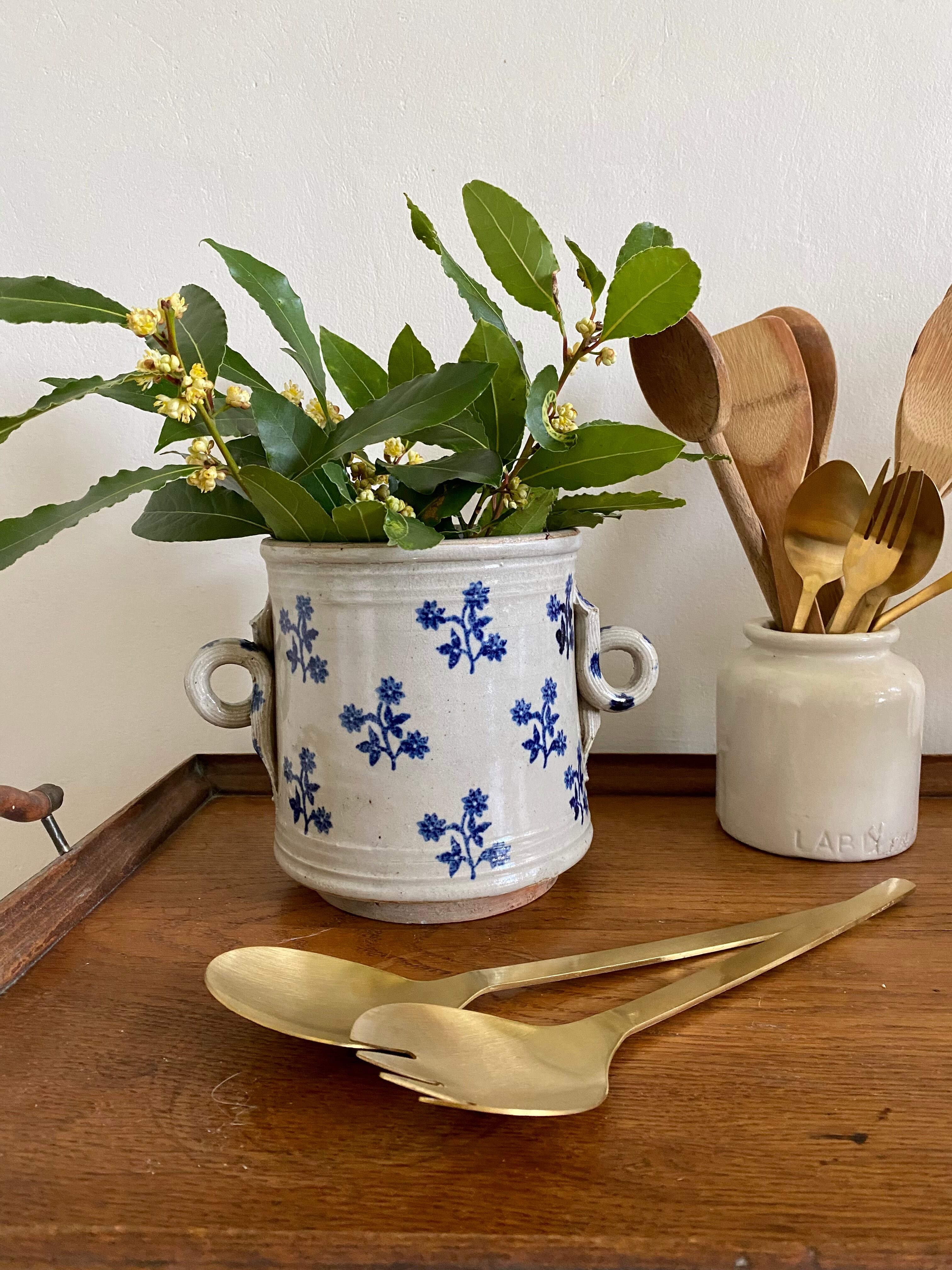 Old pot, sandstone, blue flower decoration