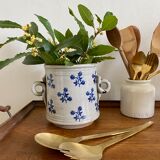 Old pot, sandstone, blue flower decoration