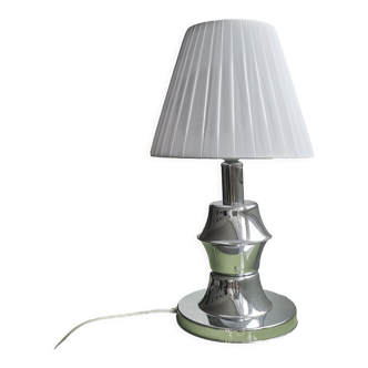 Modern chrome silver table lamp with pleated white shade.