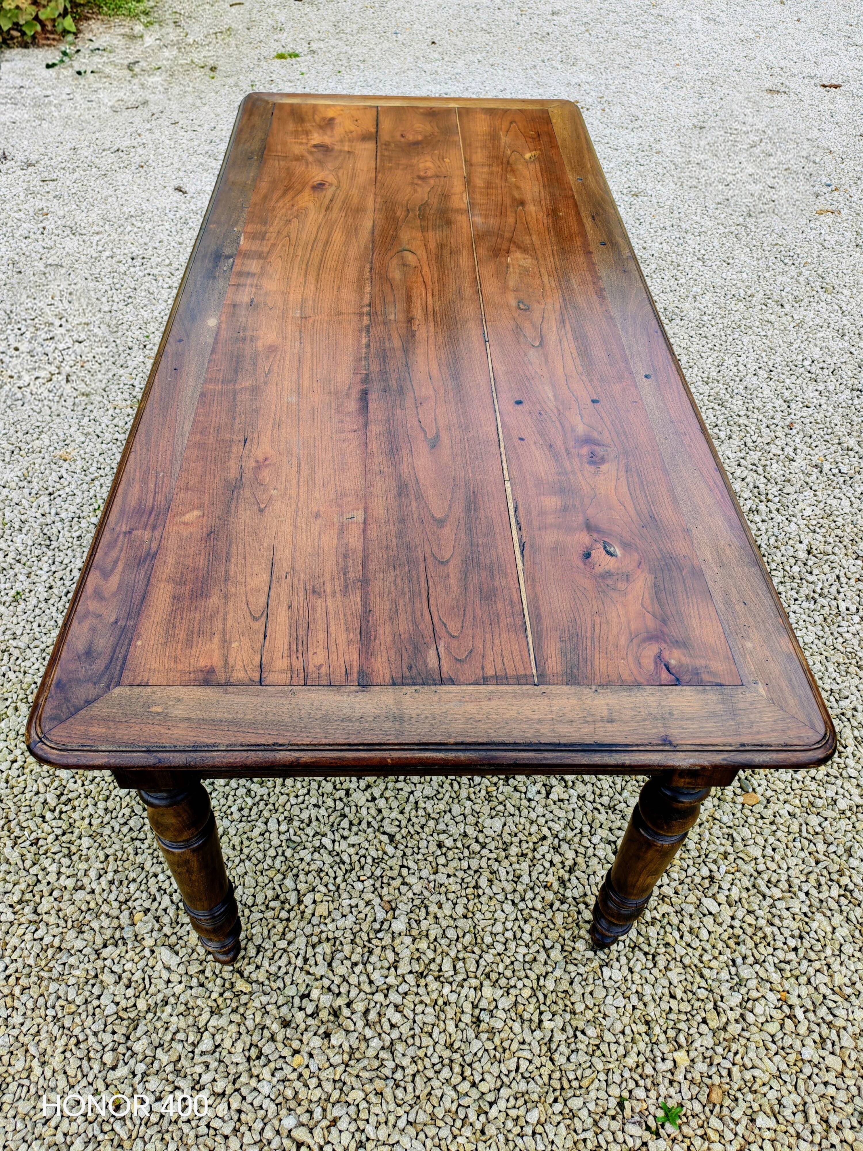 Old French farmhouse table in walnut with turned legs.