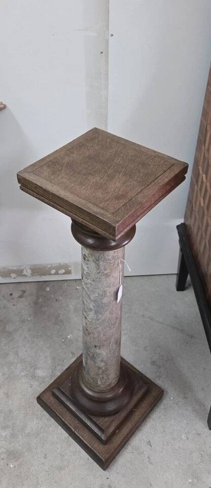 Column-shaped pedestal, made of solid wood and faux marble paint.