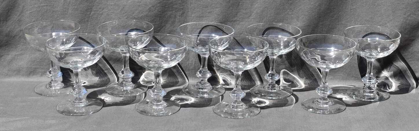9 old champagne glasses in flat-waisted blown glass