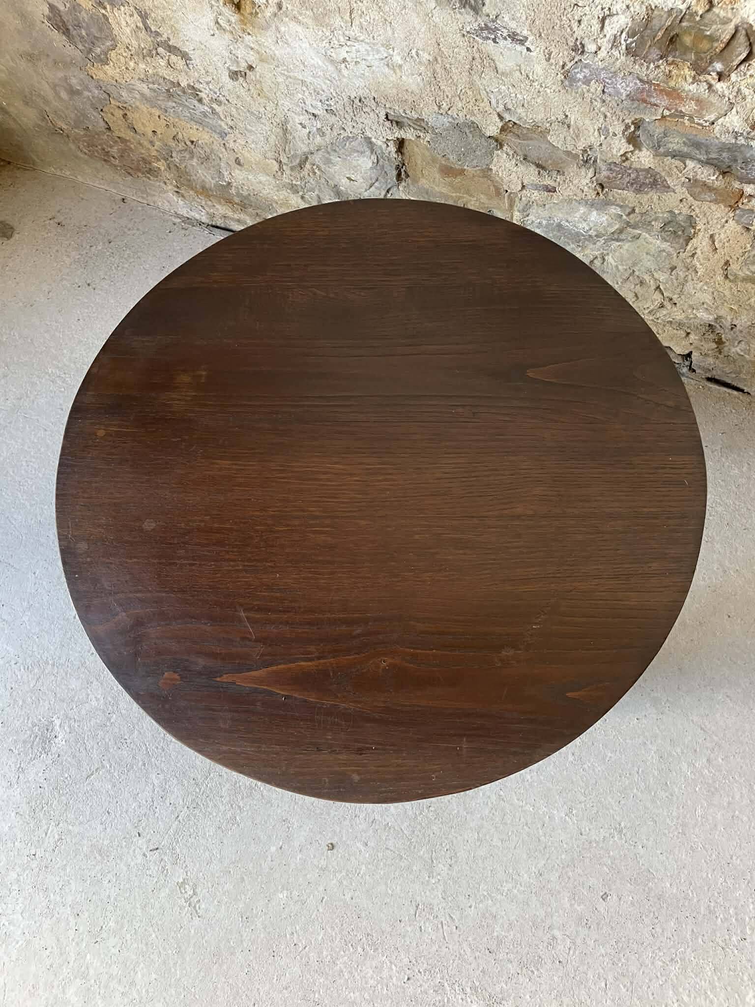 Round wooden coffee table with turned legs.