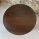 Round wooden coffee table with turned legs.