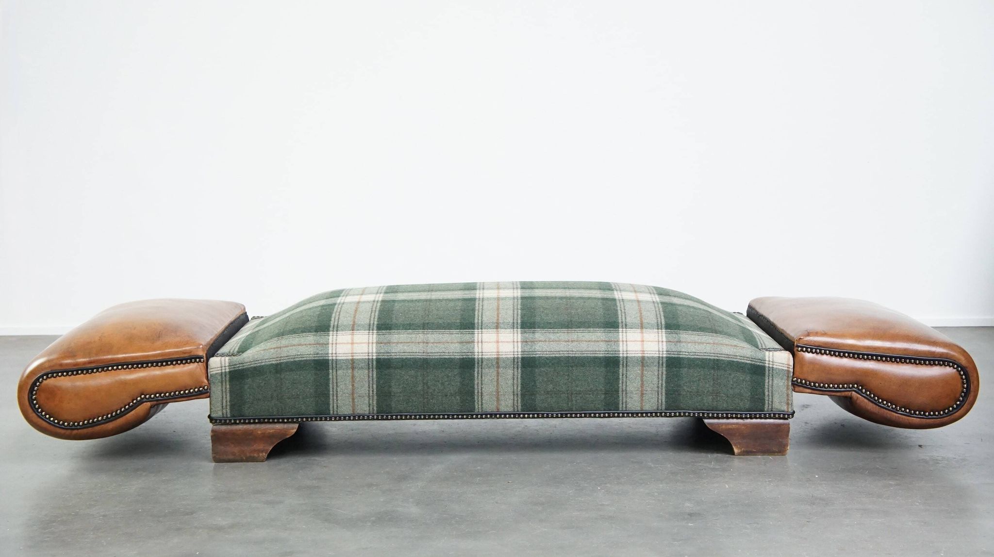 Antique daybed reupholstered with sheepskin and Scottish tartan wool