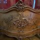 Large wooden display cabinet in Louis XV/rococo style with a strongly curved front.