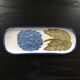 Hortensia-decorated stoneware plate signed
