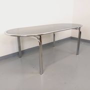 Vintage oval dining table in smoked glass and chrome metal, Space Age style.