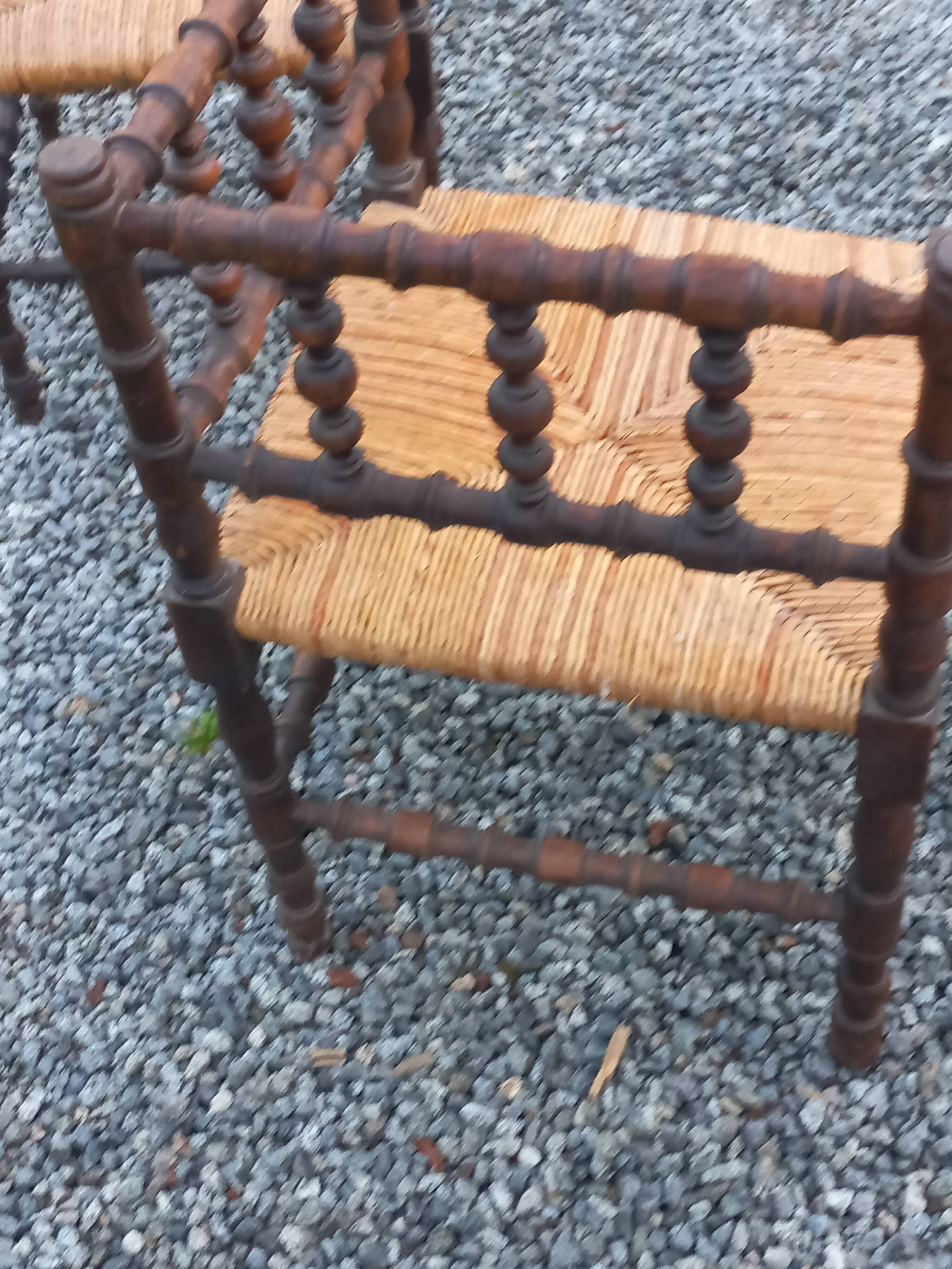 Pair of angled armchairs with turned wood and rush seats from the 1960s.