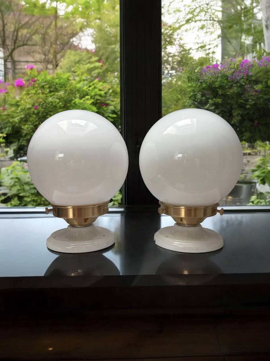 Pair of wall sconces with white opaline globes