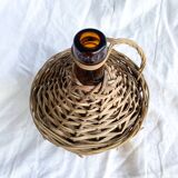 Circled with wicker demijohn