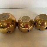 Trio of brass fleur-de-lis candle holders