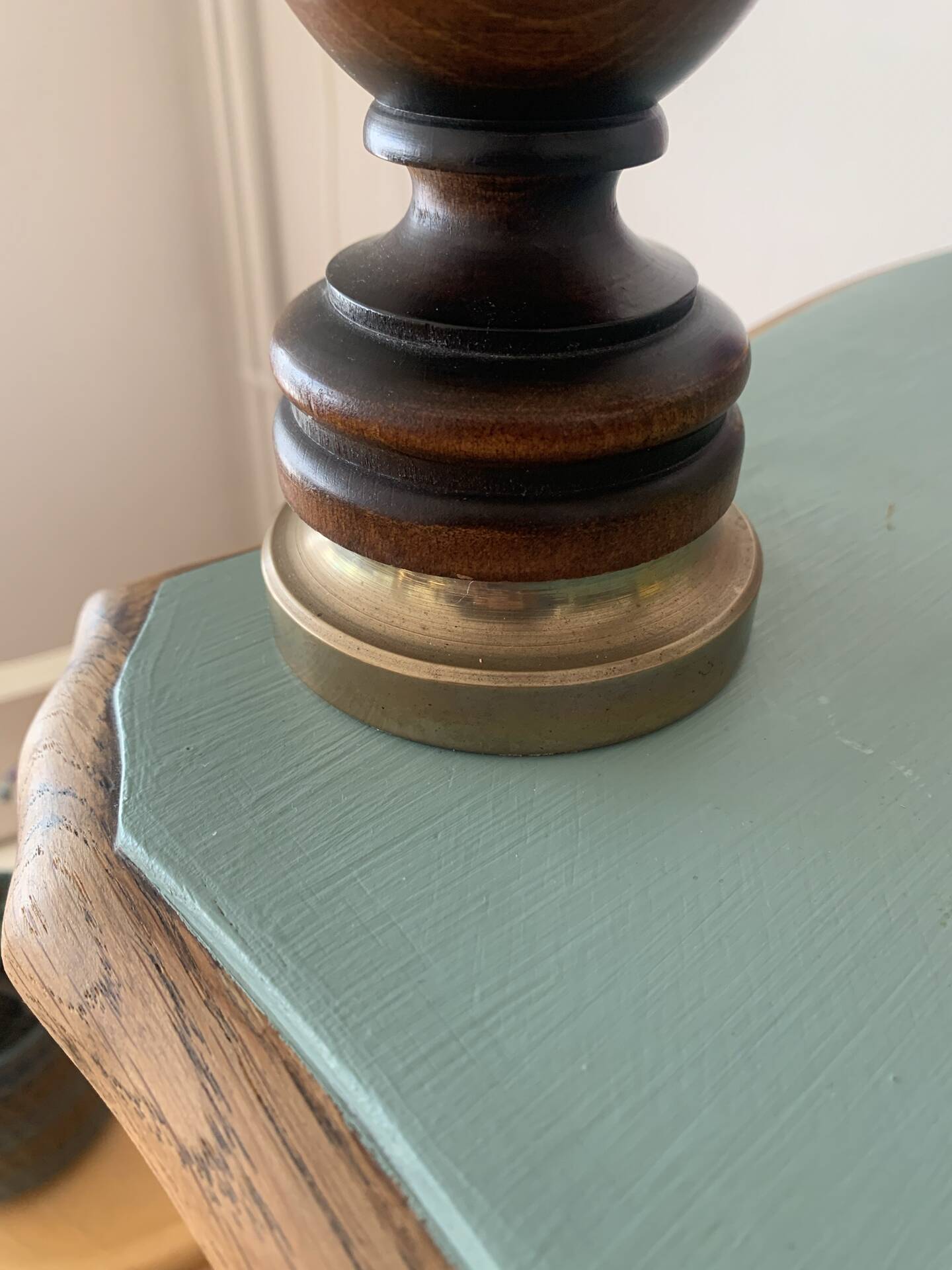 Small vintage wooden turned table lamp with a pleated shade.