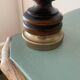 Small vintage wooden turned table lamp with a pleated shade.
