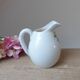 Old small jug, handmade ceramic milk pot with hand-painted floral decoration in the Vallauris style.