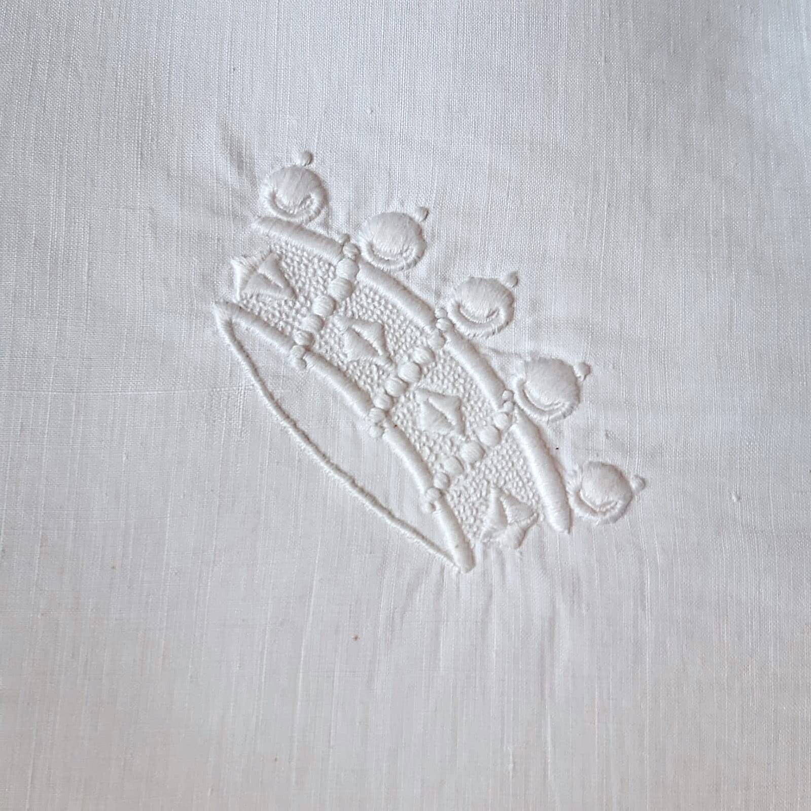 scalloped pillowcase decorated with a baron's crown