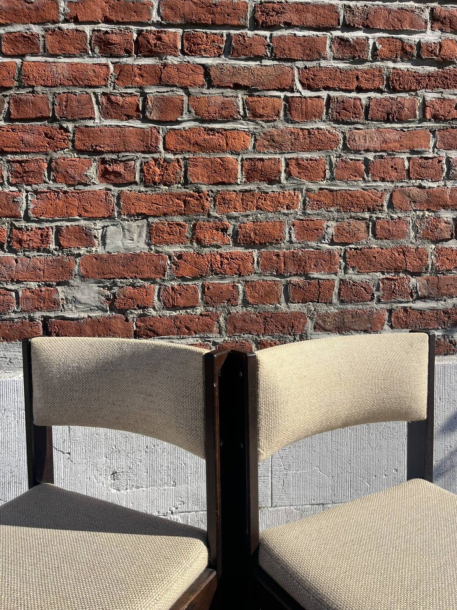 Many mid-century vintage wooden and fabric chairs.