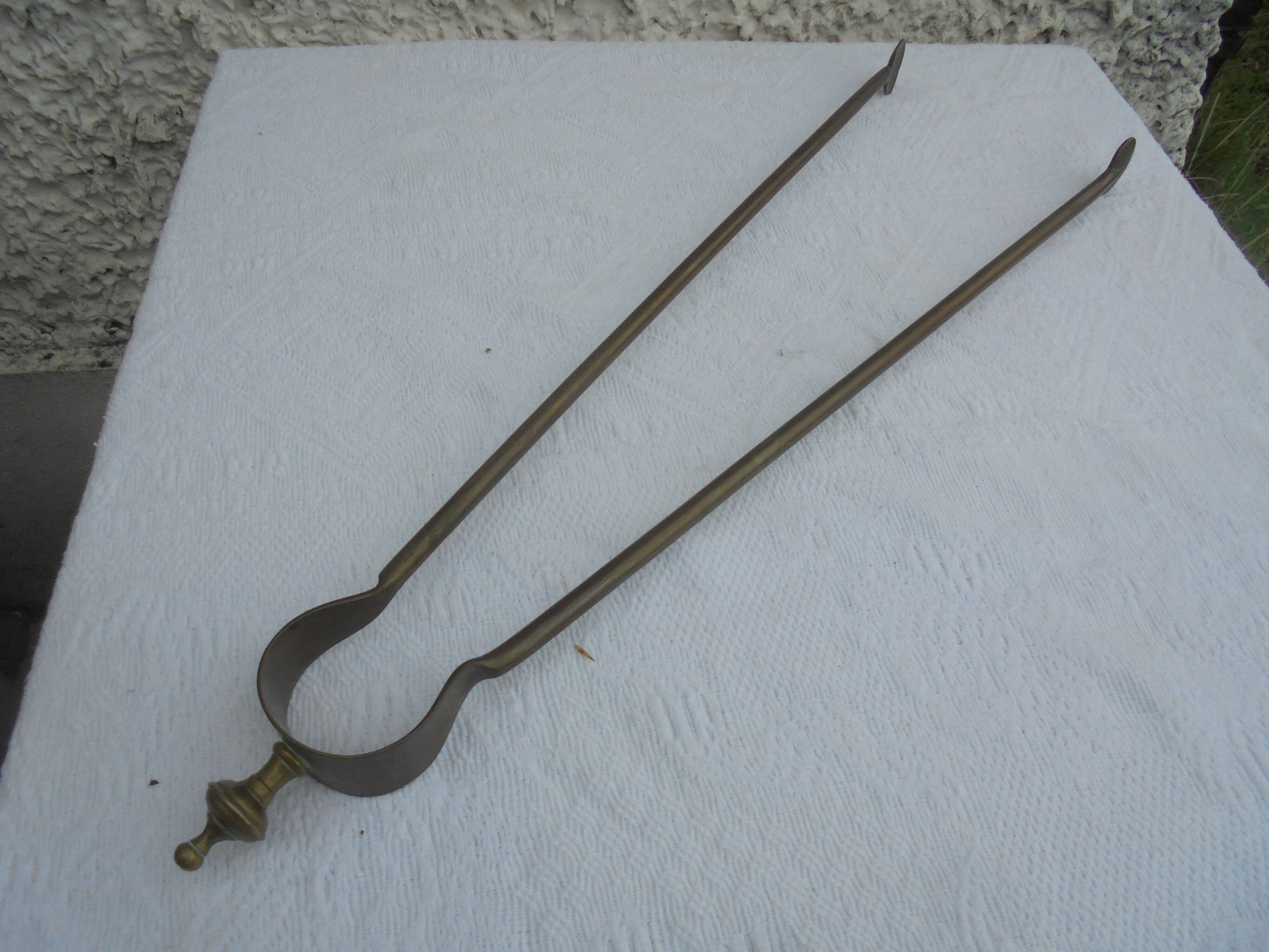 Old brass log clamp for fireplace