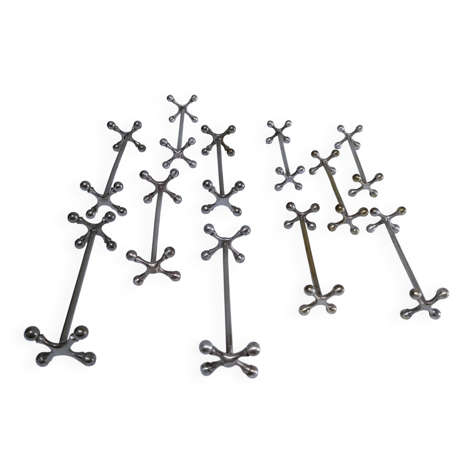 Eleven 70s design metal "crosshair" knife holders