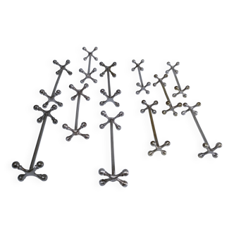 Eleven 70s design metal "crosshair" knife holders