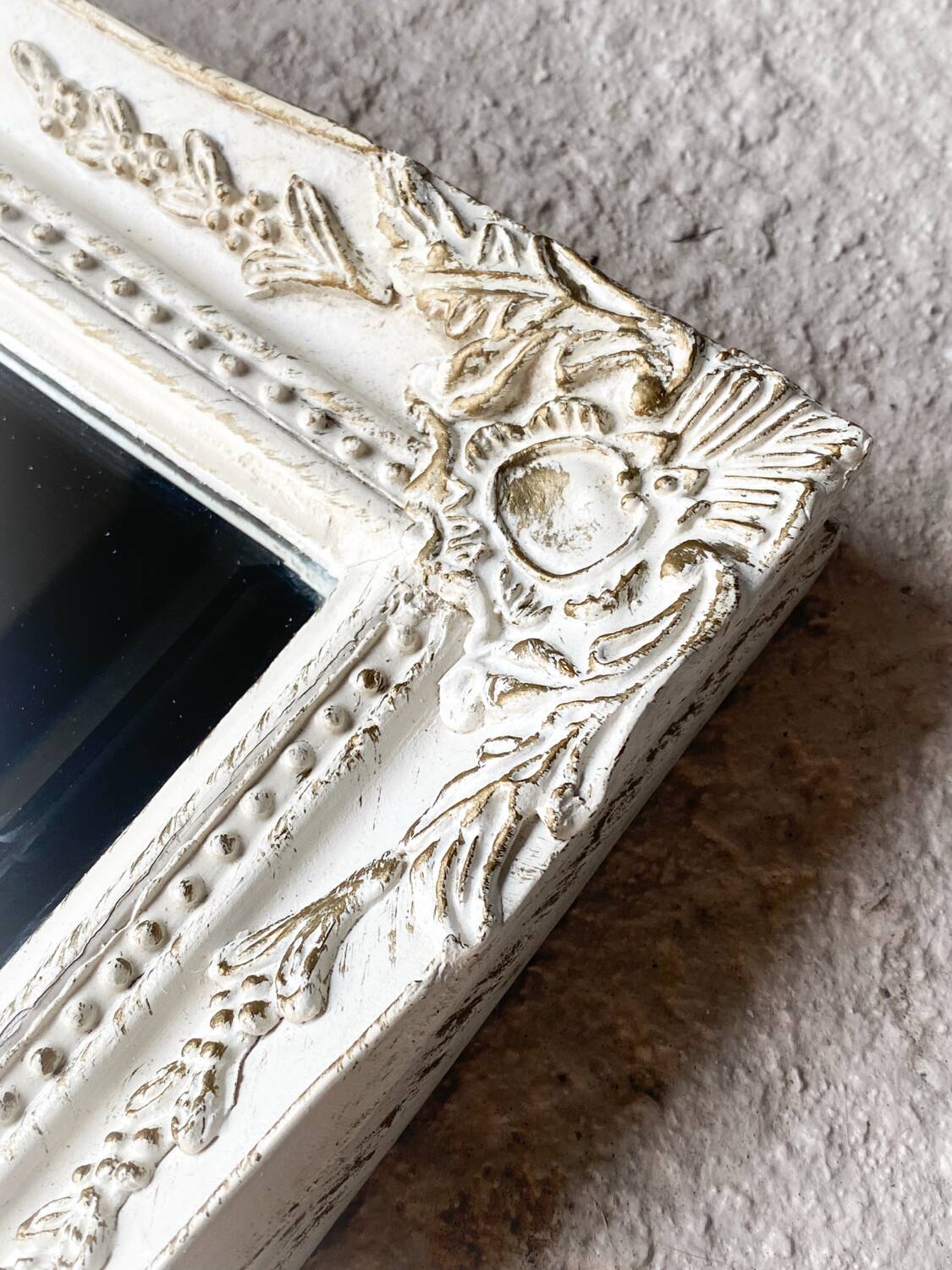 Beveled mirror in carved wood