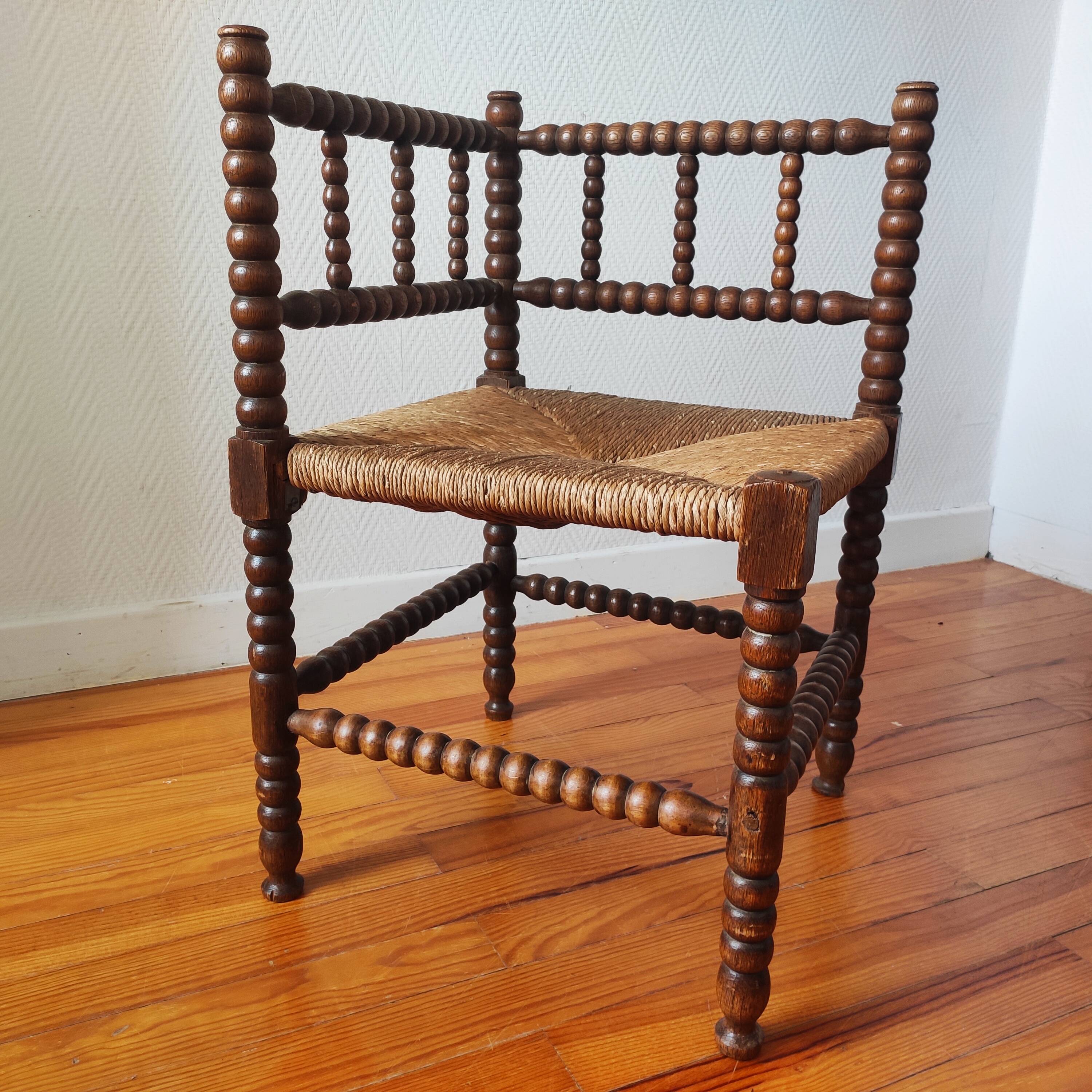 Antique corner chair made of turned wood spindle.