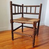 Antique corner chair made of turned wood spindle.