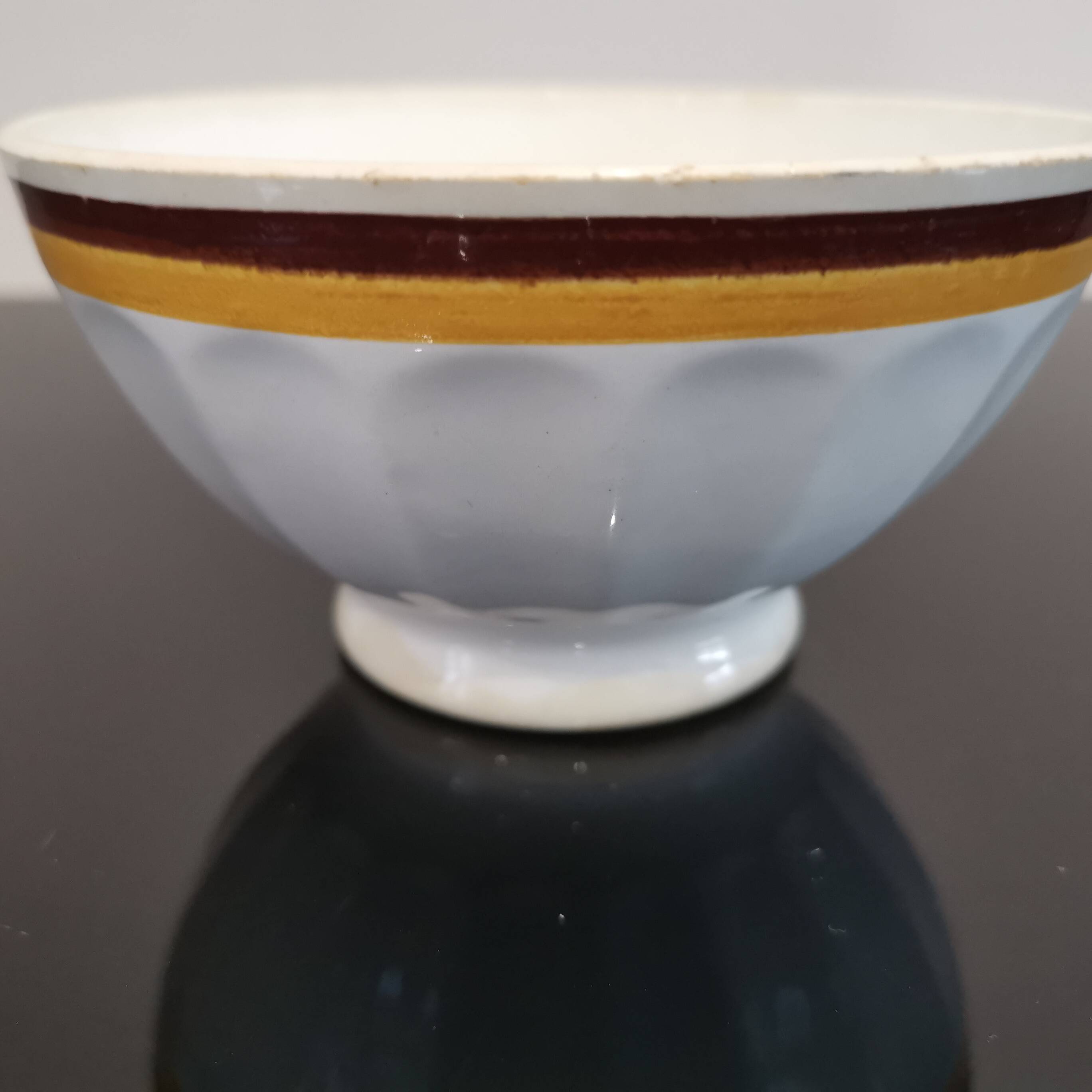 Authentic Vintage ceramic faceted bowl decorated with a double border