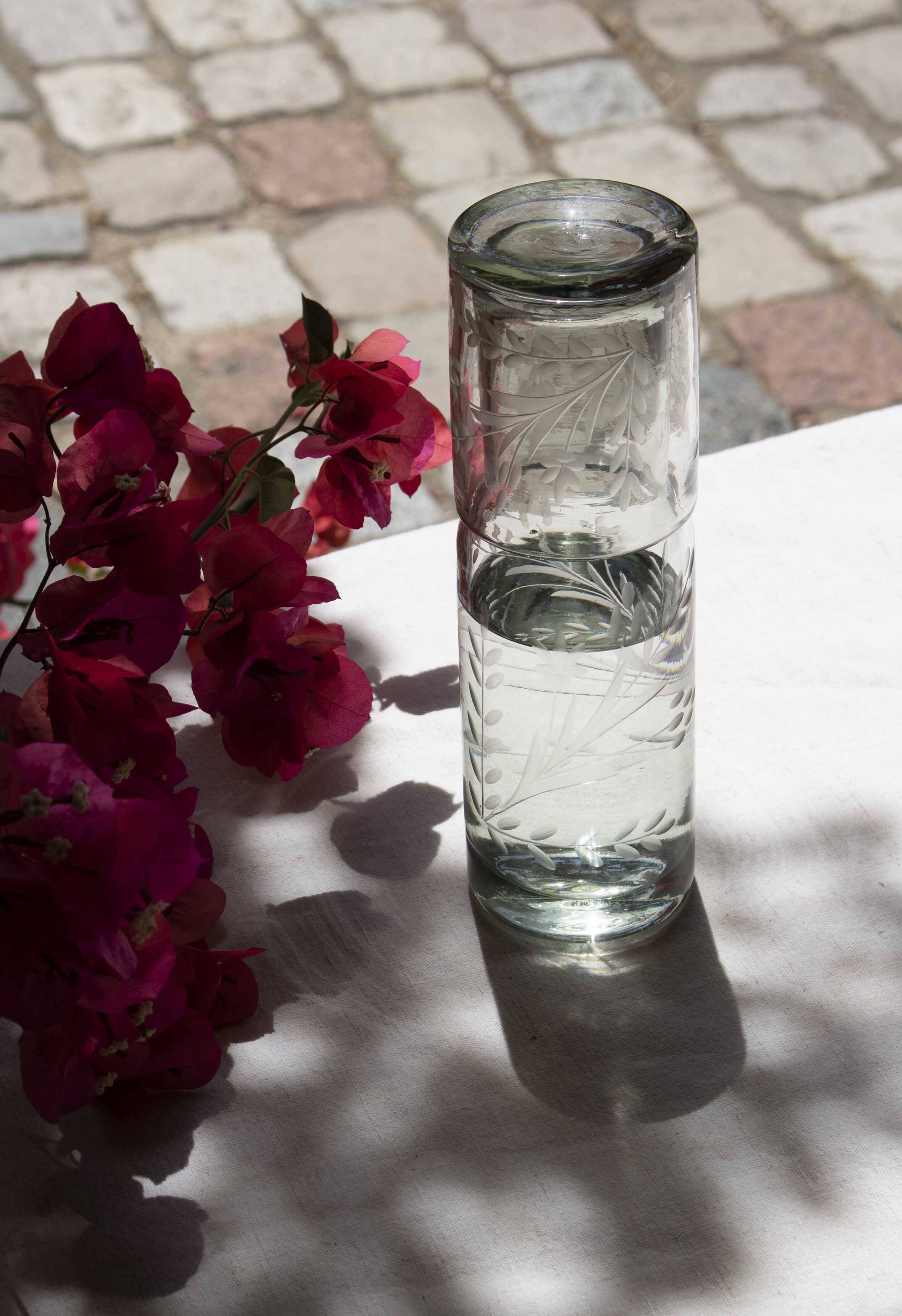 Carafe and glass made of blown and engraved glass.
