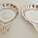 Silver-plated shell-shaped butter dishes, in the shape of a scallop shell.