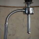 Flexible floor lamp, chrome, opaque white shade with metallic edges.