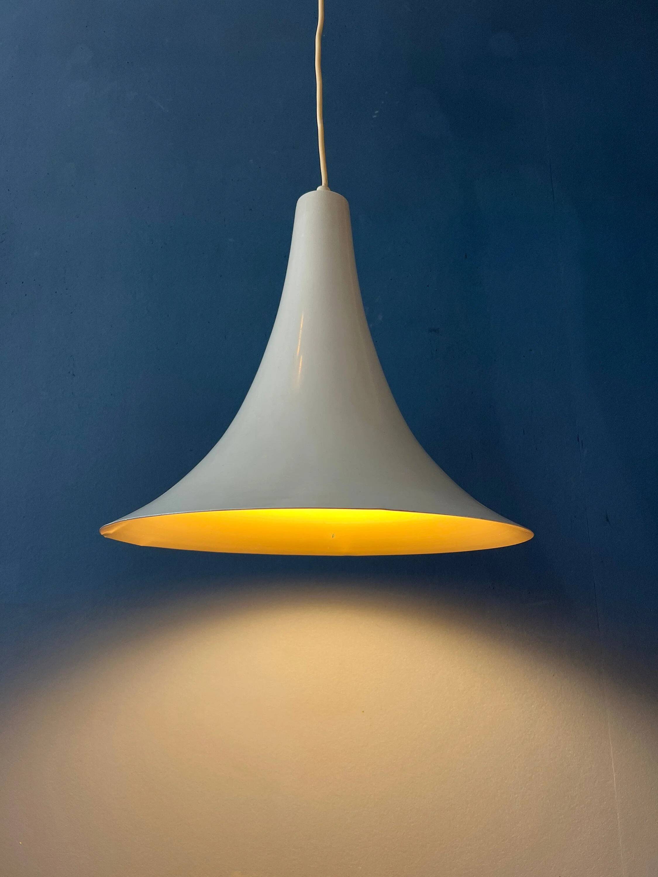 Small vintage beige pendant light in the shape of a witch's hat.