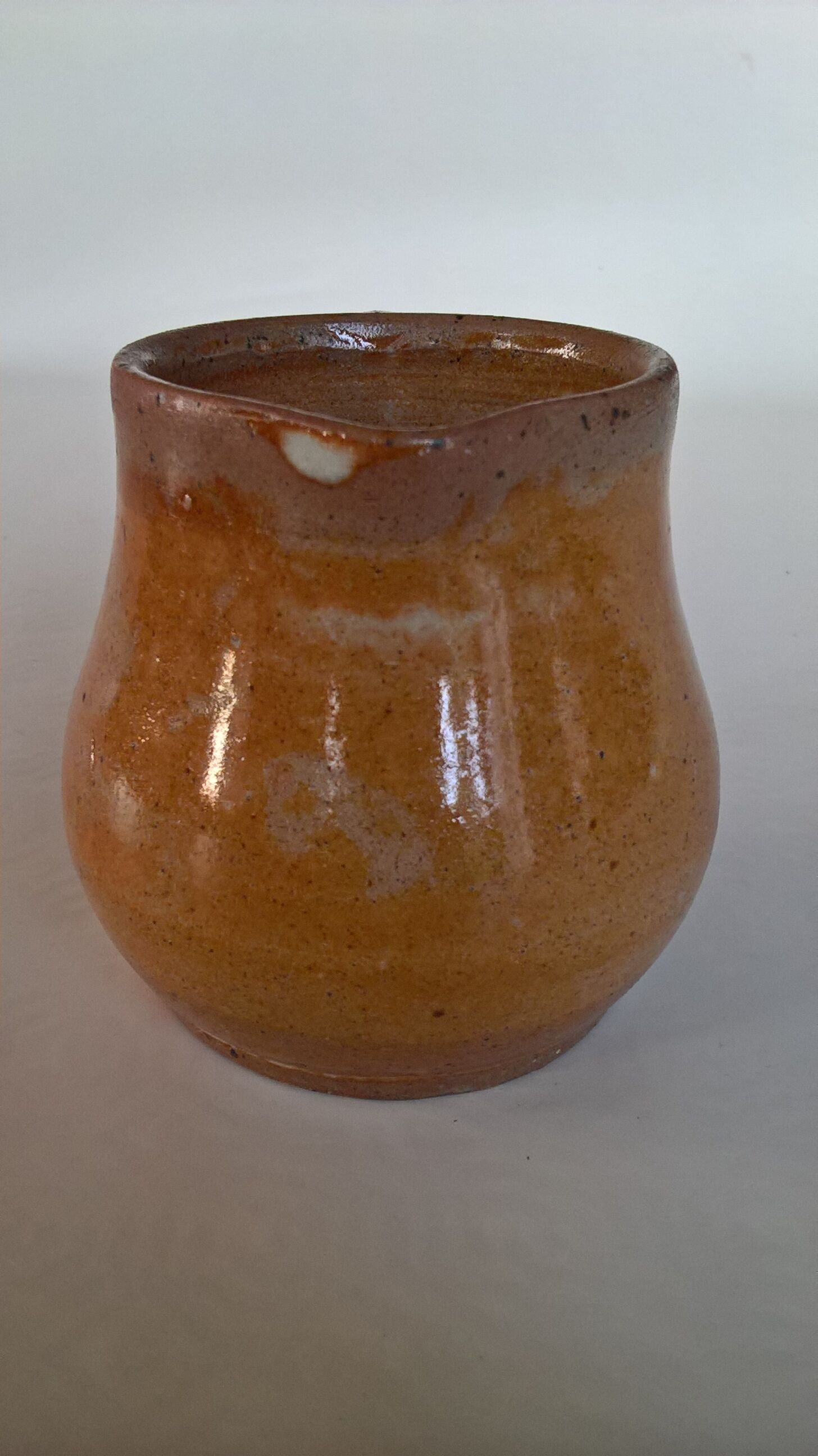 Creamy milk pot in sandstone