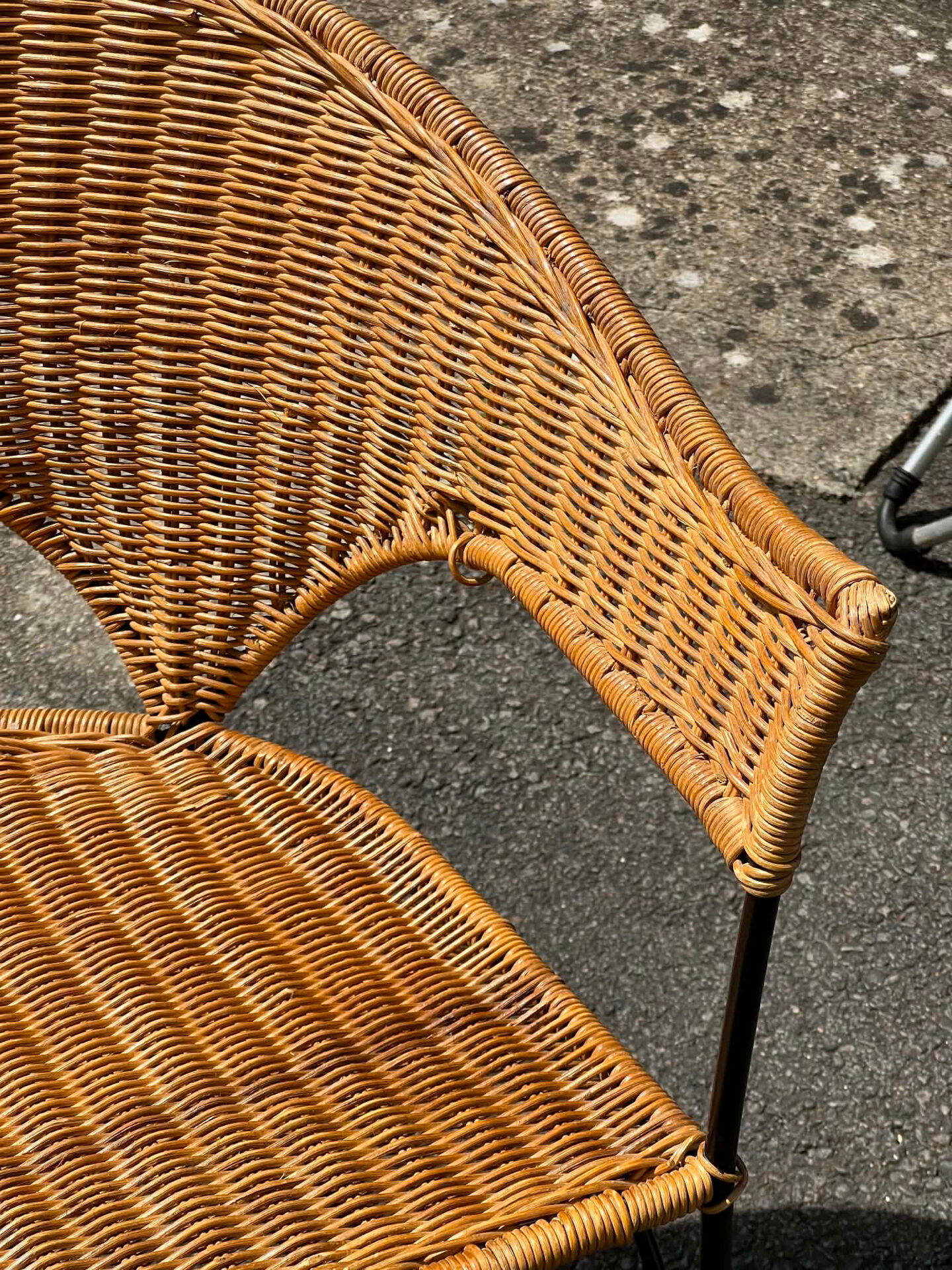 Wicker and black wrought iron armchair