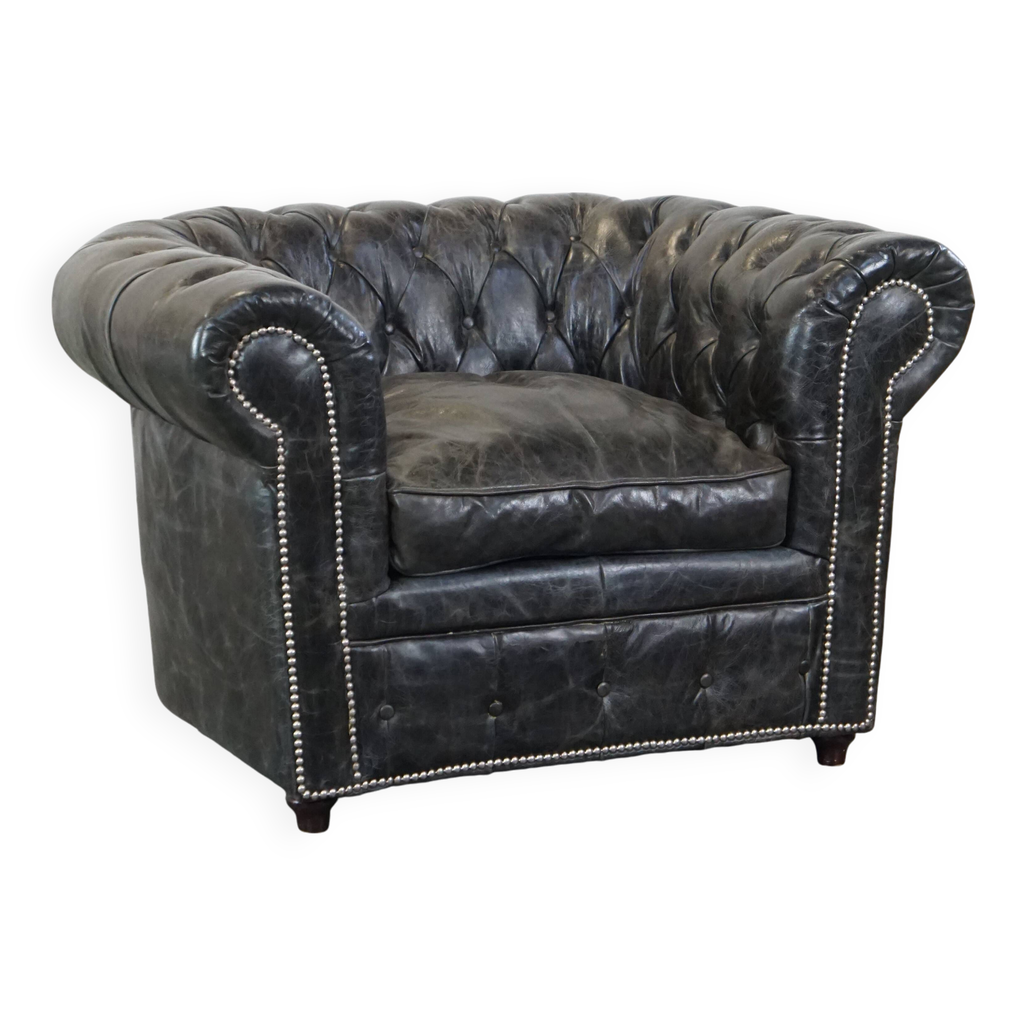 Spacious black cow leather chesterfield armchair with distinctive character