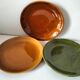 Set of green and amber enamelled plates