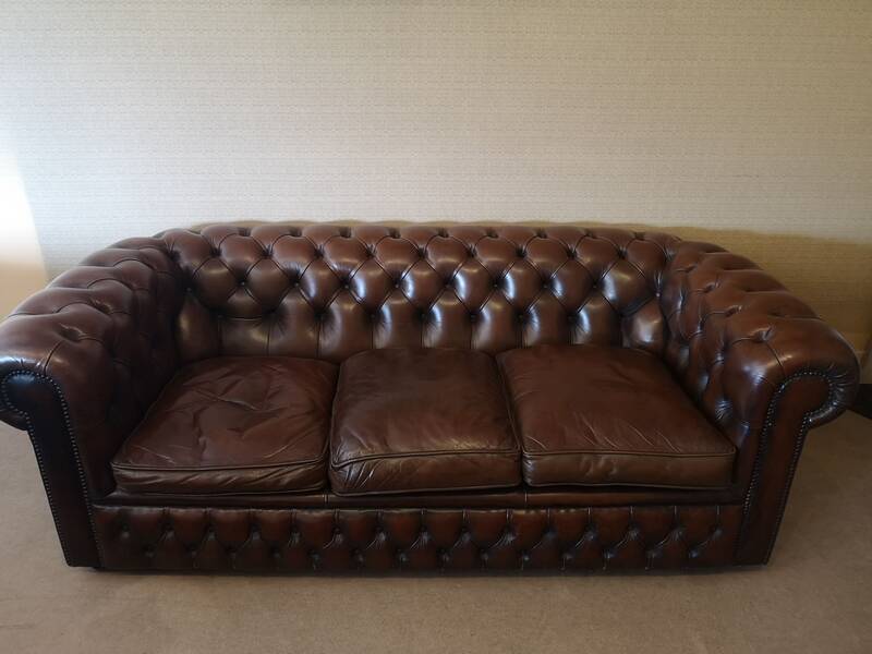 Vintage three-seater brown leather Chesterfield sofa