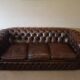 Vintage three-seater brown leather Chesterfield sofa