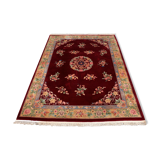 China wool fringed rug with floral pattern on deep plum background 393x274cm