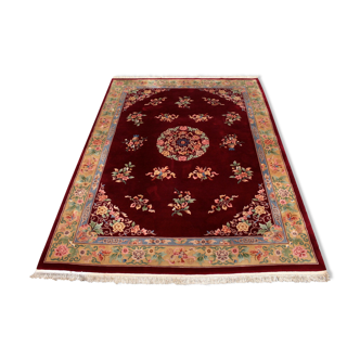 China wool fringed rug with floral pattern on deep plum background 393x274cm