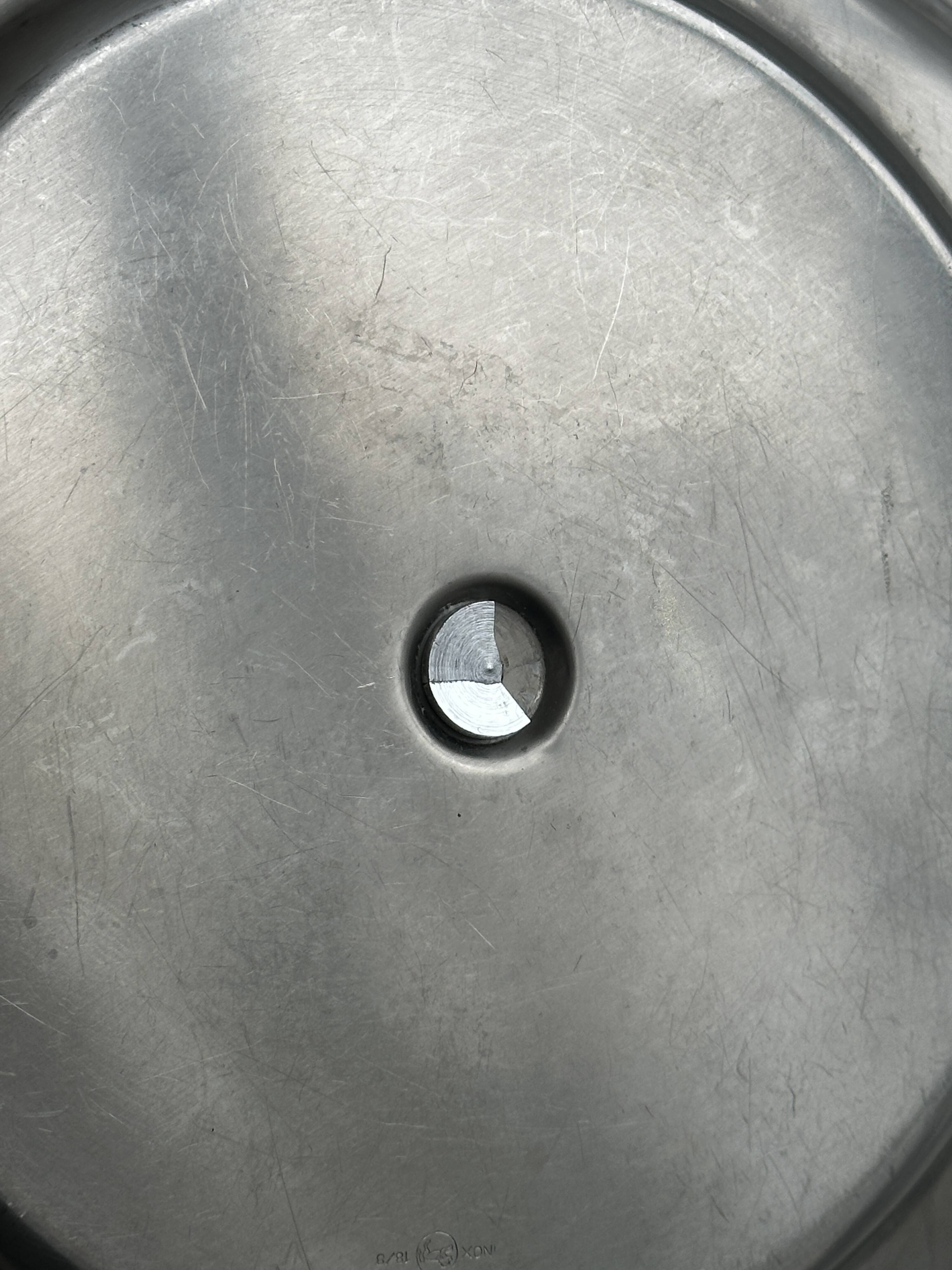 Three-tiered serving trolley in shiny stainless steel.