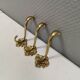 Three old and beautiful brass hooks with decorative motifs