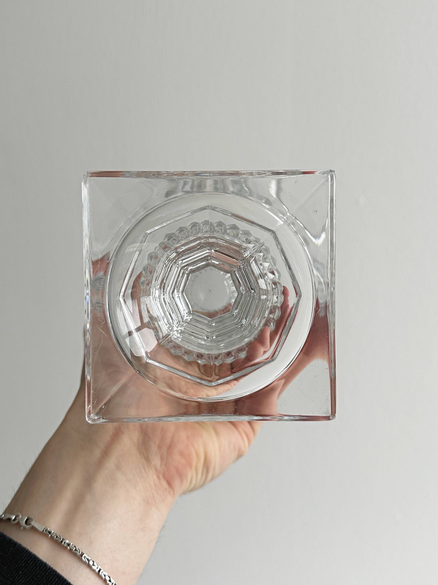 Antique thick glass vase on a pedestal.