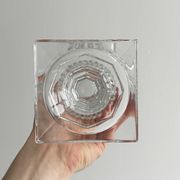 Antique thick glass vase on a pedestal.