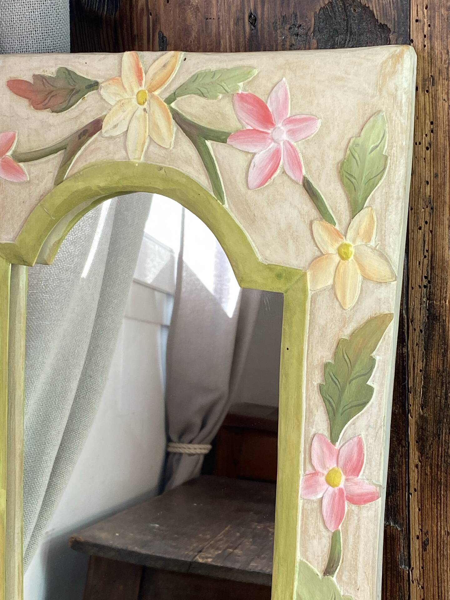Carved wooden mirror, colourful floral decoration.