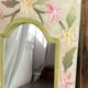 Carved wooden mirror, colourful floral decoration.